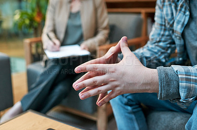 Buy stock photo Cropped shot of a man having a therapeutic session with a psychologist