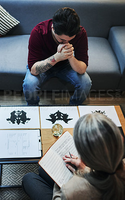Buy stock photo Shot of a psychologist conducting an inkblot test with her patient during a therapeutic session