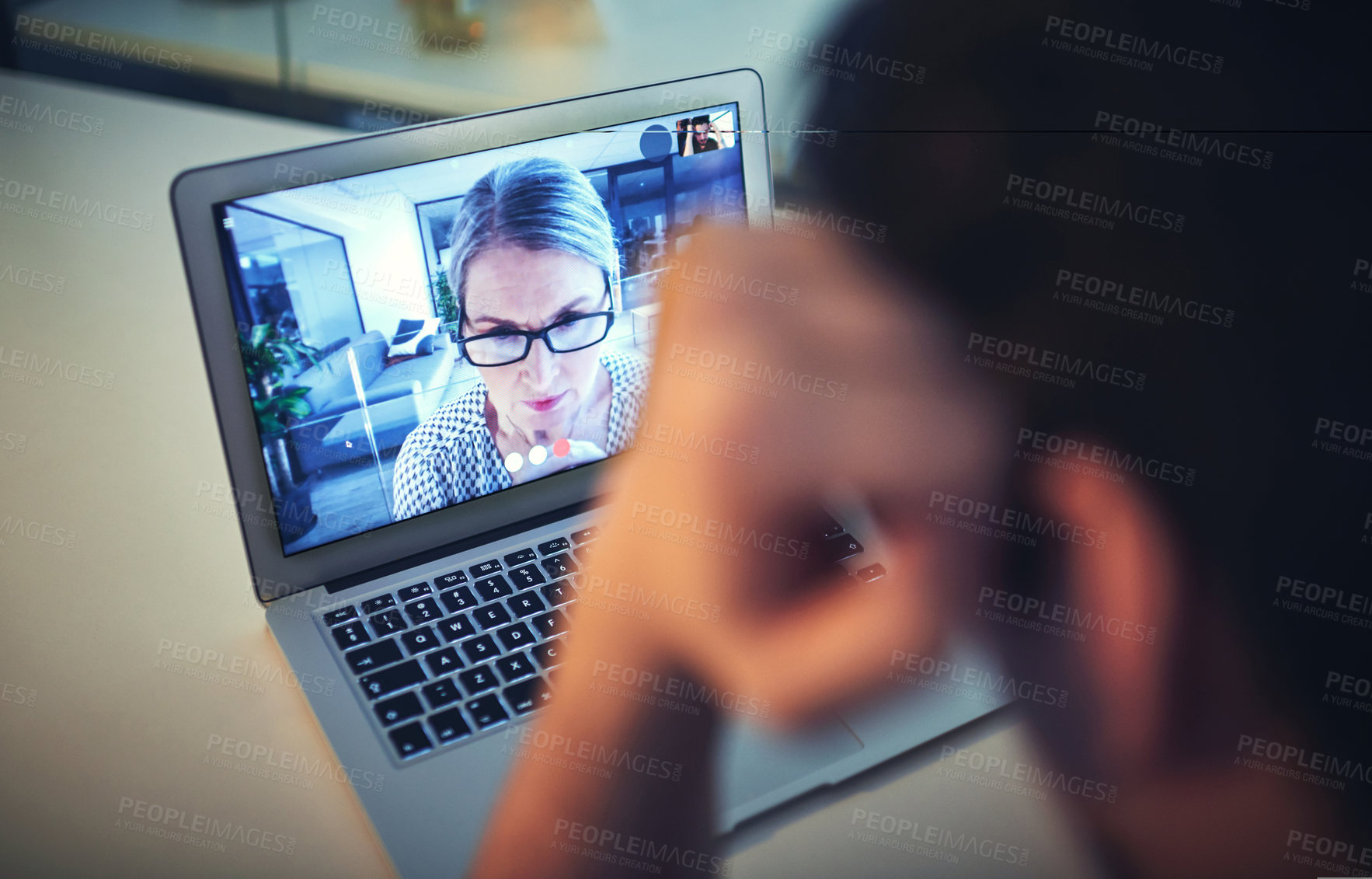 Buy stock photo Shot of a mature psychologist conducting an online therapy session with her patient