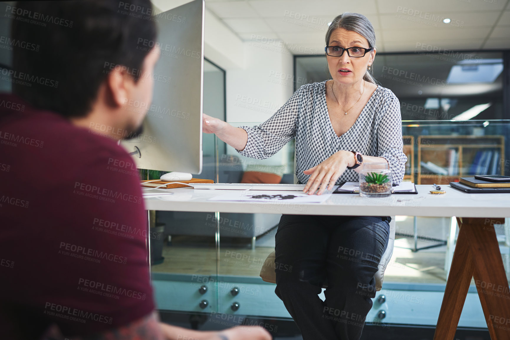 Buy stock photo Shot of a young man having a therapeutic session with a psychologist