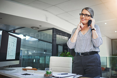 Buy stock photo Shot of a confident mature psychologist using a smartphone in a modern office