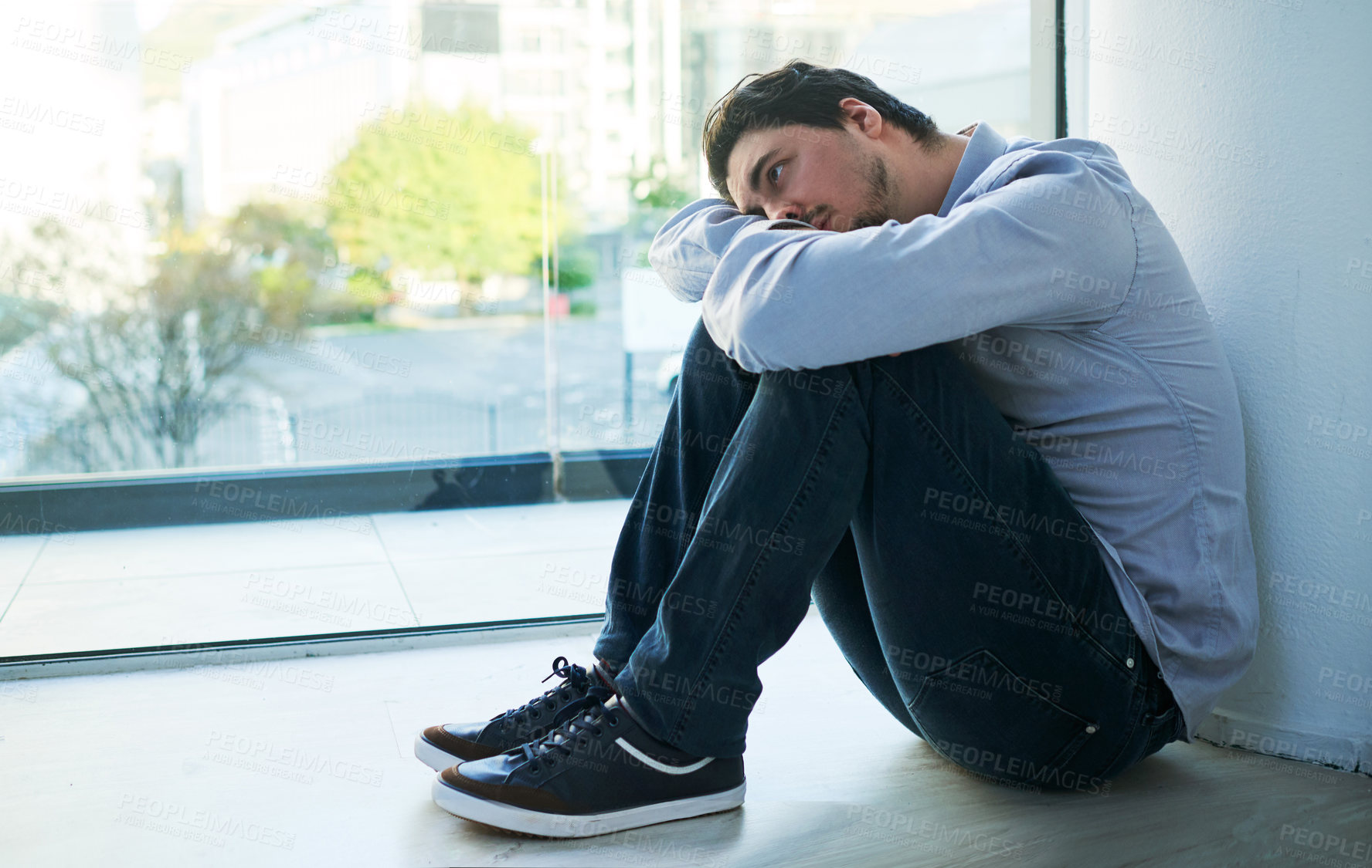 Buy stock photo Shot of a young man suffering from a mental breakdown