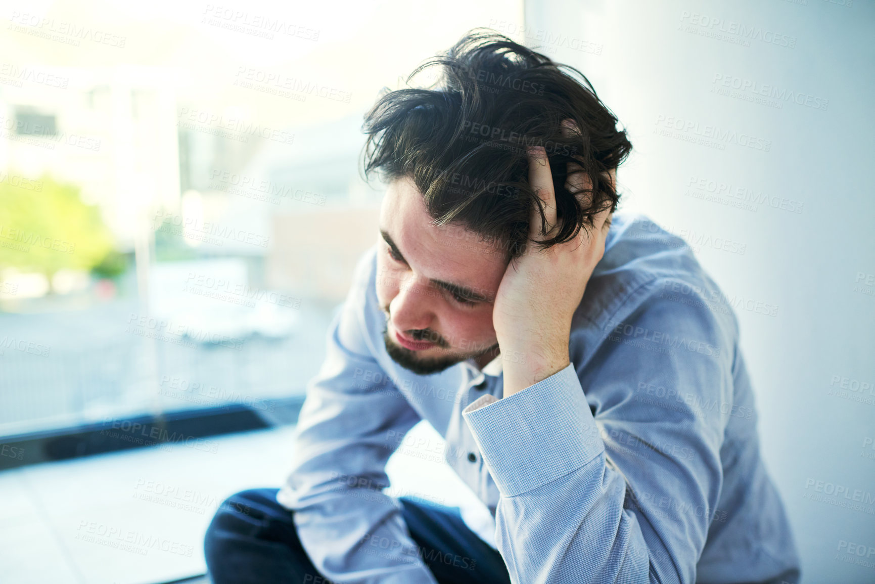 Buy stock photo Shot of a young man suffering from a mental breakdown
