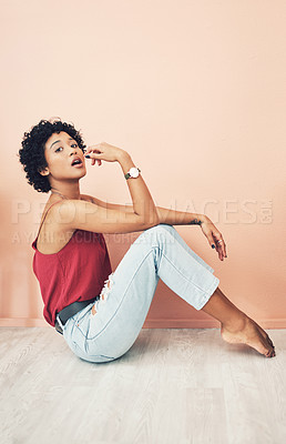 Buy stock photo Shot of a beautiful young woman striking a pose while sitting on the floor