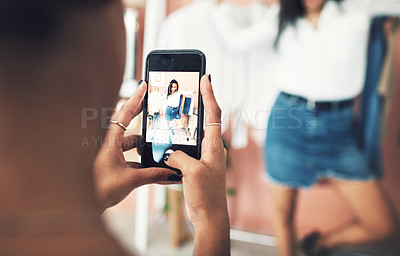 Buy stock photo Shot of a blogger having her picture taken on a smartphone