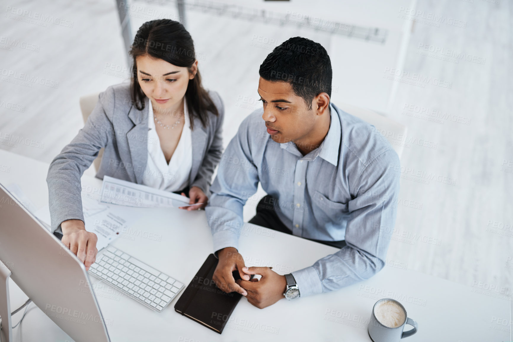 Buy stock photo Shot of a young businessman and businesswoman using a computer in a modern office