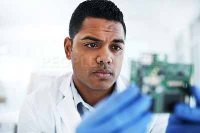 Buy stock photo Shot of a young man repairing computer hardware in a laboratory