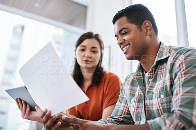 Buy stock photo Shot of a young businessman and businesswoman having a meeting in a modern office