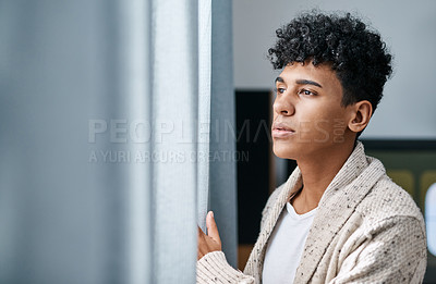 Buy stock photo Shot of a young man opening his bedroom curtains in the morning at home