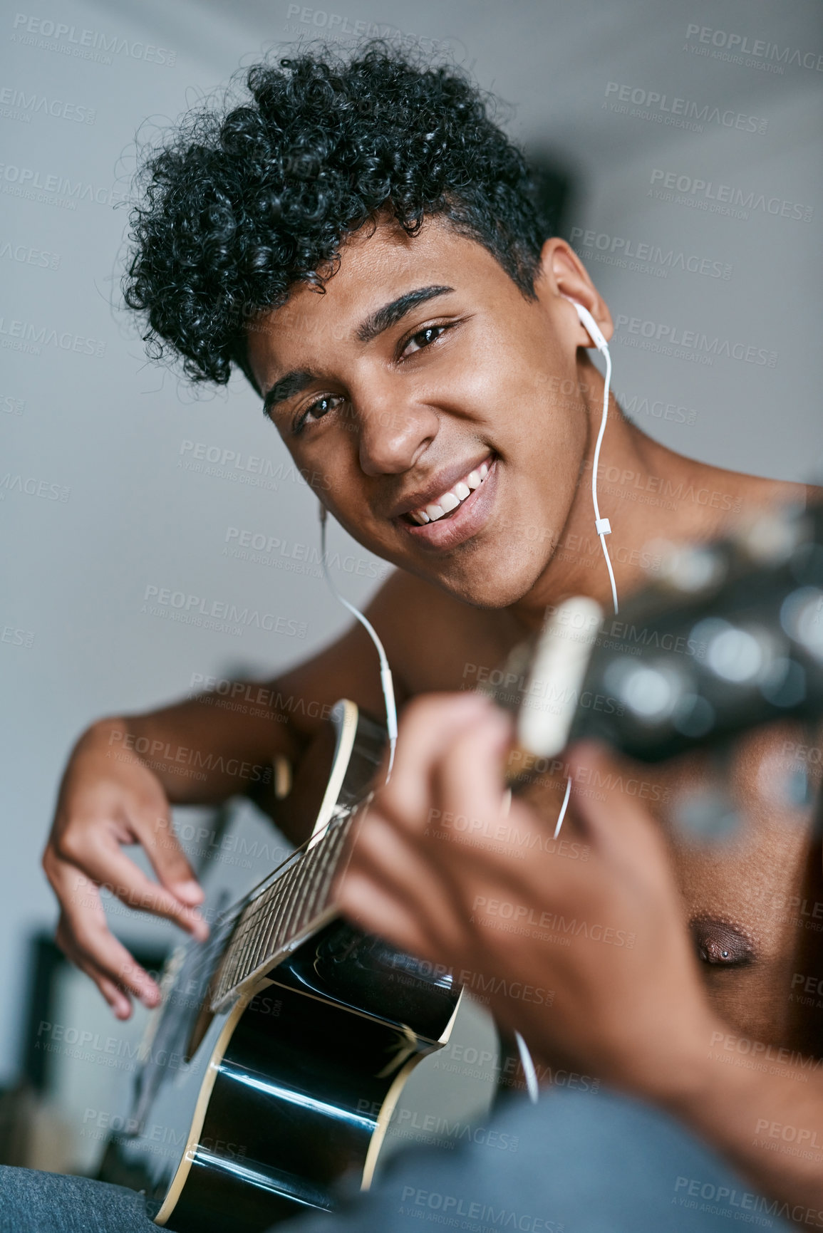 Buy stock photo Guitar, earphones and portrait of man in home playing music for learning chords, tuning or songwriting with creativity. Artist, acoustic instrument and male person relaxing in bedroom with strings.