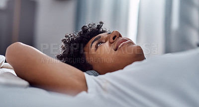 Buy stock photo Shot of a young man relaxing on his bed at home