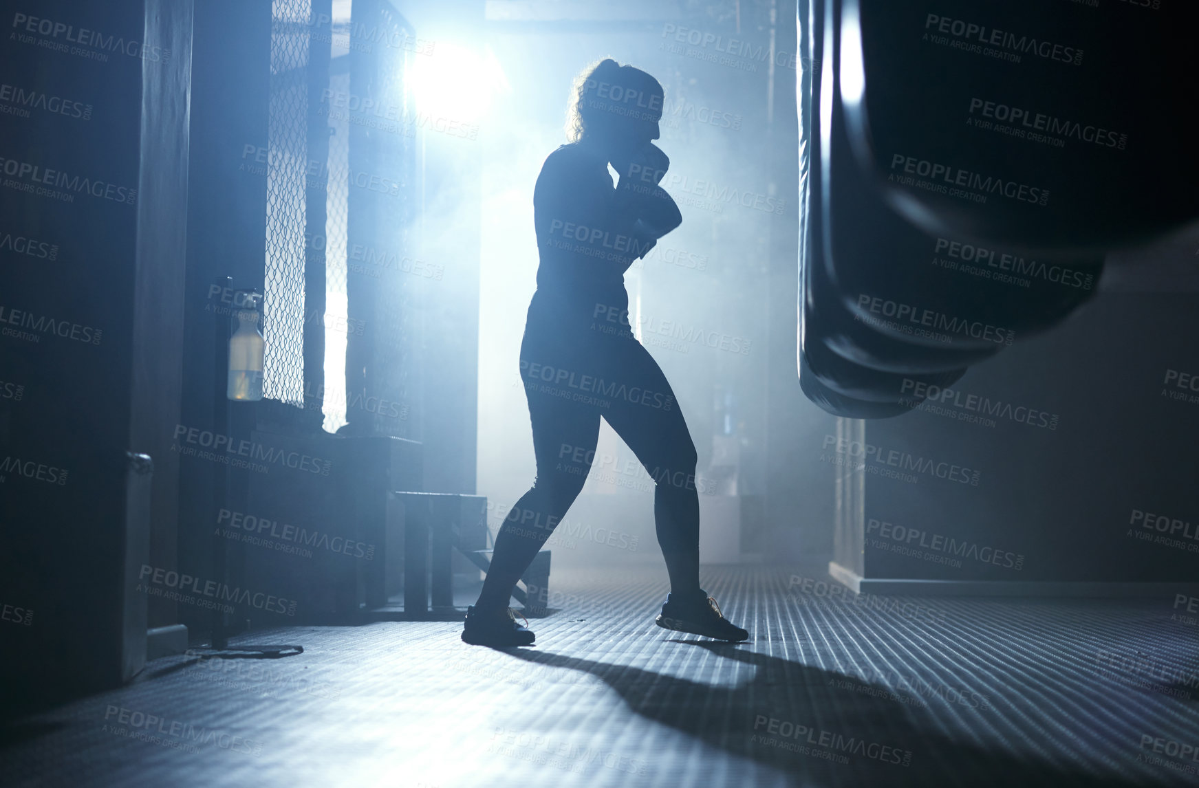 Buy stock photo Boxing, training and person in gym, dark and practice with punching bag, action and energy for sport. Exercise, healthy and boxer with skills for competition, workout and performance of fighter