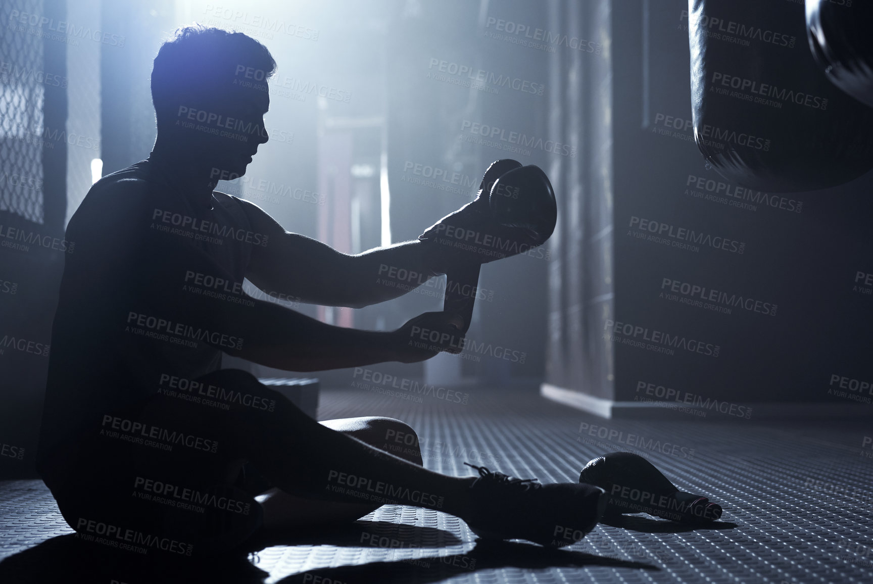 Buy stock photo Man, boxing gloves and exercise as professional boxer in silhouette at fitness center for challenge. Male person, athlete and power for fight with strong muscle or training for championship in sports