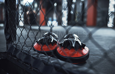 Buy stock photo Still life shot of a pair of boxing mitts in a gym
