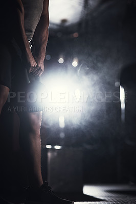 Buy stock photo Closeup shot of an unrecognisable man exercising with a kettlebell in a gym