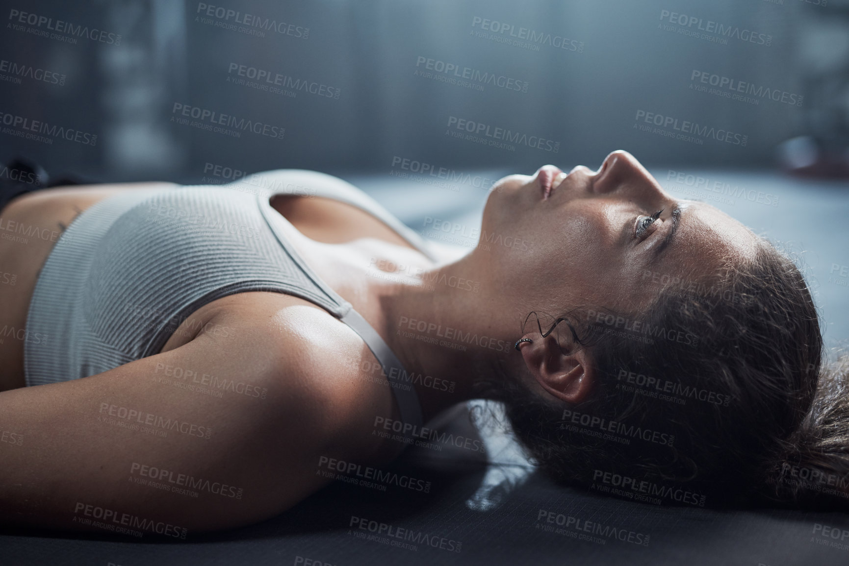 Buy stock photo Shot of a young woman taking a break from her workout at the gym