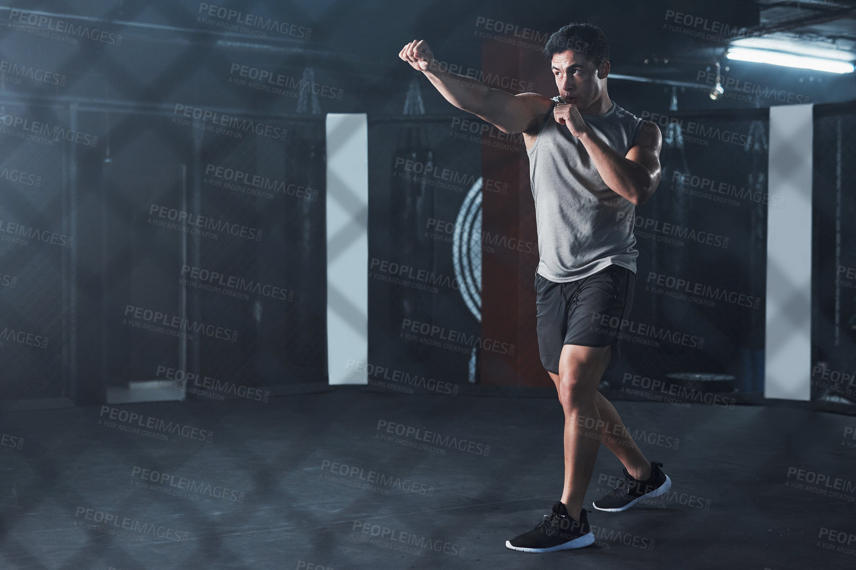 Buy stock photo Boxing, man and fitness with punch at gym of mma workout, sports training and fight performance. Strong, male boxer and practice for power challenge, self defence and resilience of combat competition