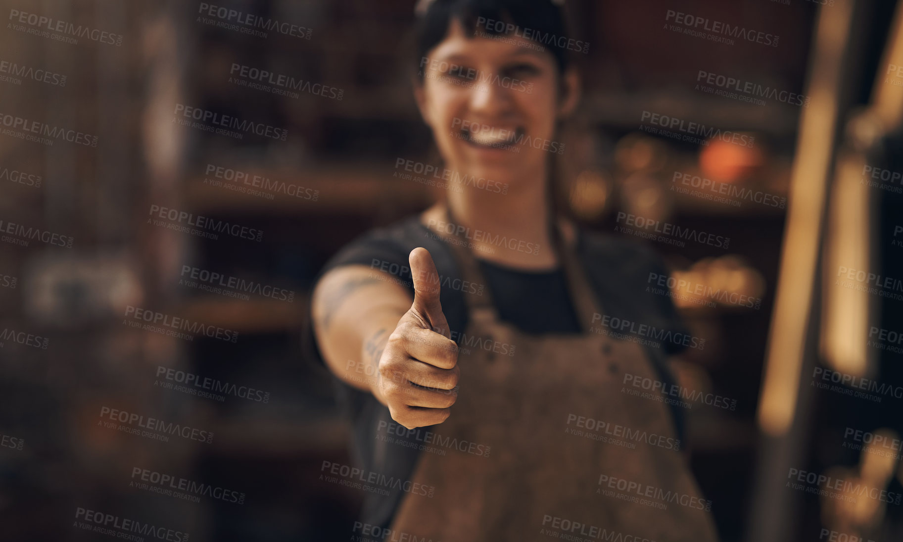 Buy stock photo Thumbs up, factory and woman blacksmith in workshop for industry, manufacturing and manual labor. Industrial warehouse, welding and female person with hand sign for steel, iron and metal production