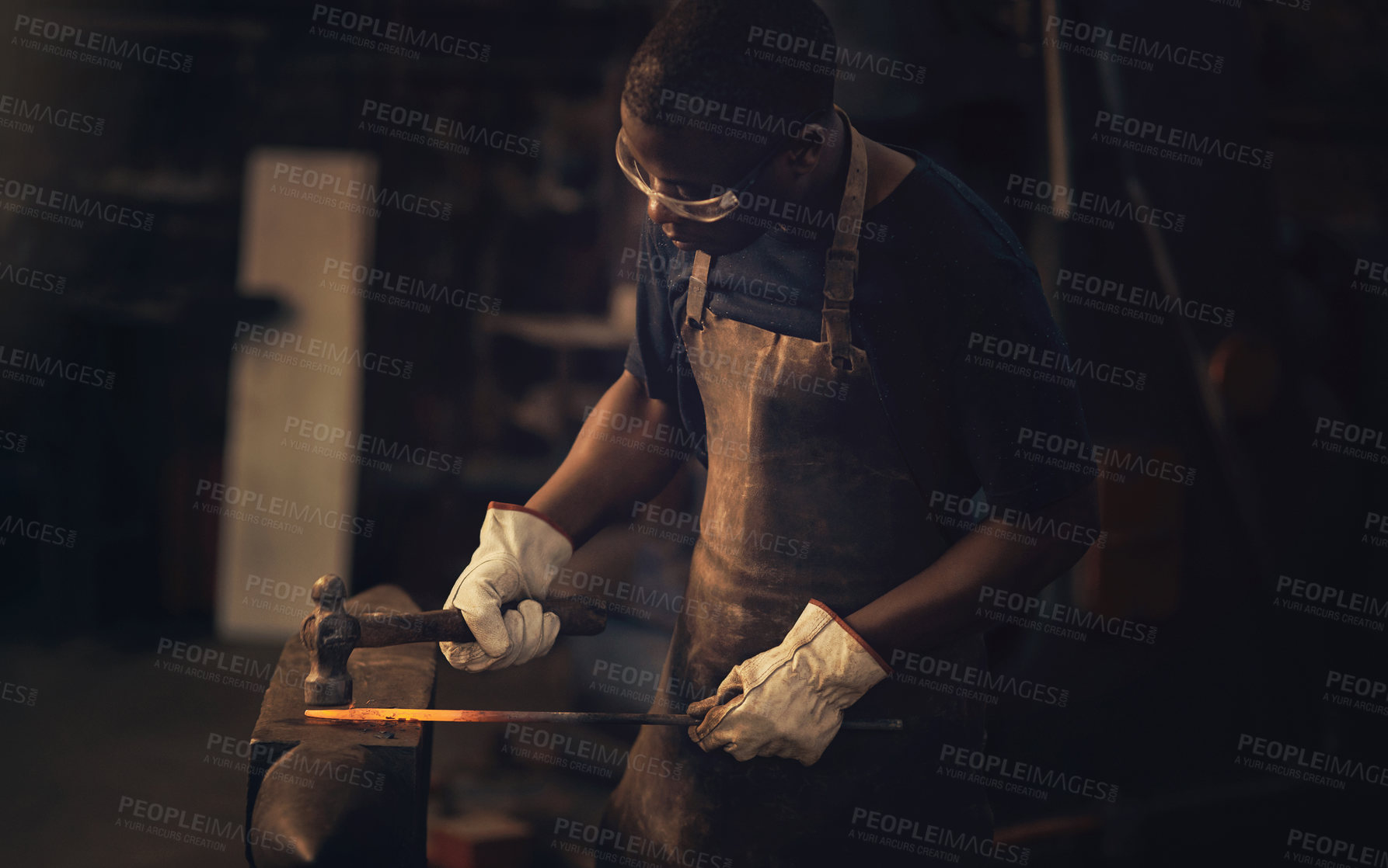 Buy stock photo Foundry, worker and man with hammer for metal, molten steel or industrial forge with professional craft. Workshop, male person or blacksmith with tools for manufacturing, production or factory career