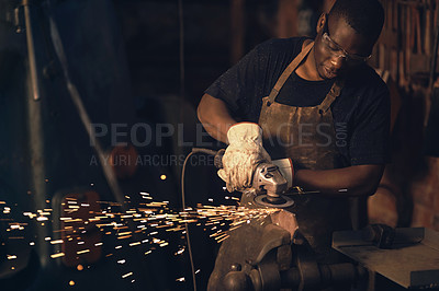 Buy stock photo Shot of a young man using an angle grinder while working at a foundry