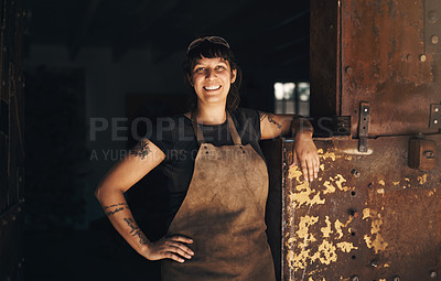 Buy stock photo Woman blacksmith, portrait and smile in factory, industry and trade for entrepreneurship at artisan job. Small business owner, female entrepreneur and labor in industrial warehouse with manufacturing