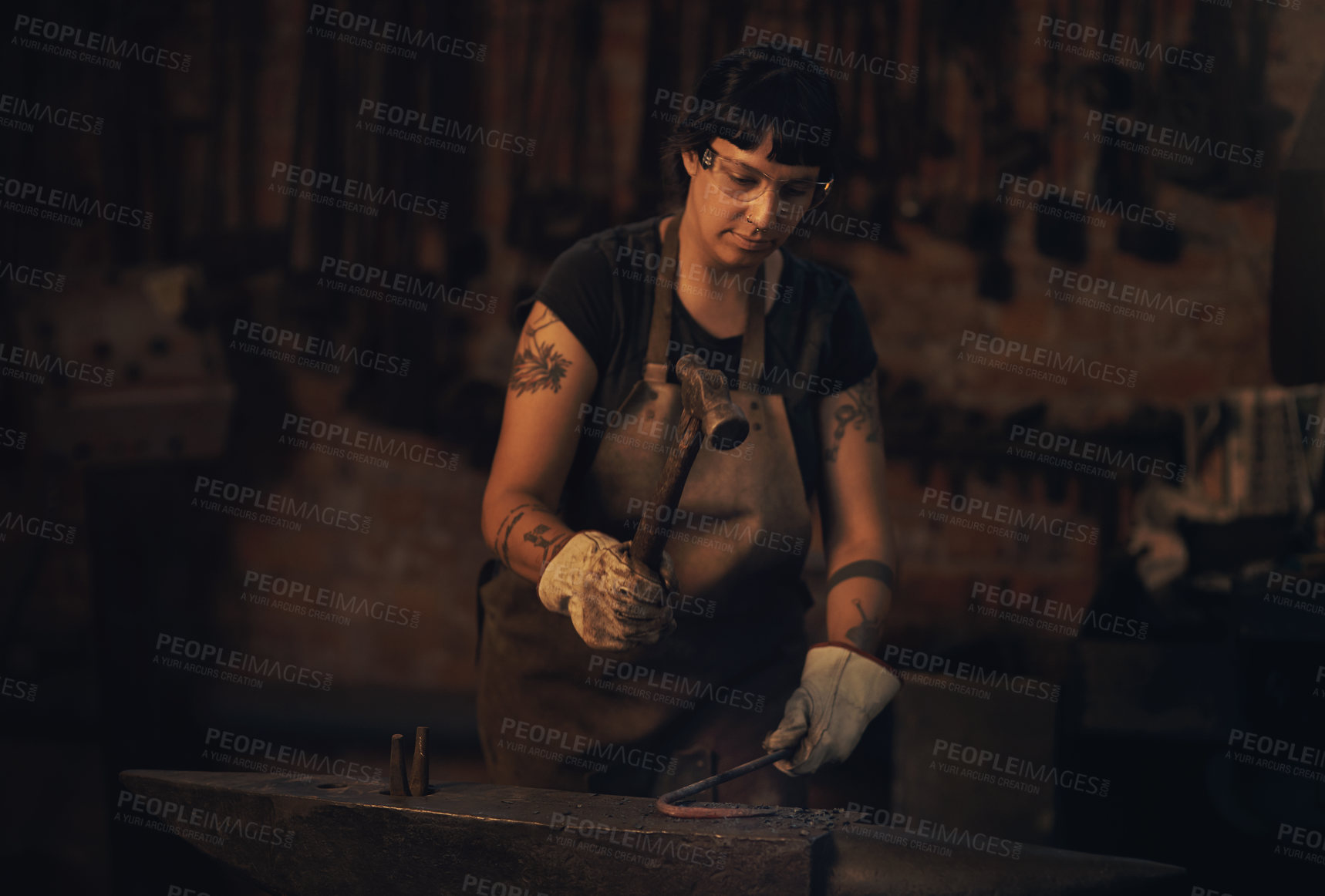 Buy stock photo Welding, dark and woman with steel, workshop and proud of gender equality in foundry and blacksmith. Hardworking, apron and manufacturing in factory, person and skills for welder and confident