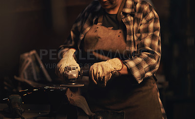 Buy stock photo Shot of a woman using an angle grinder while working at a foundry