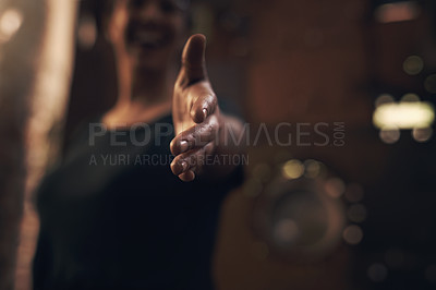 Buy stock photo Cropped shot of an unrecognisable woman extending her arm for a handshake at a foundry
