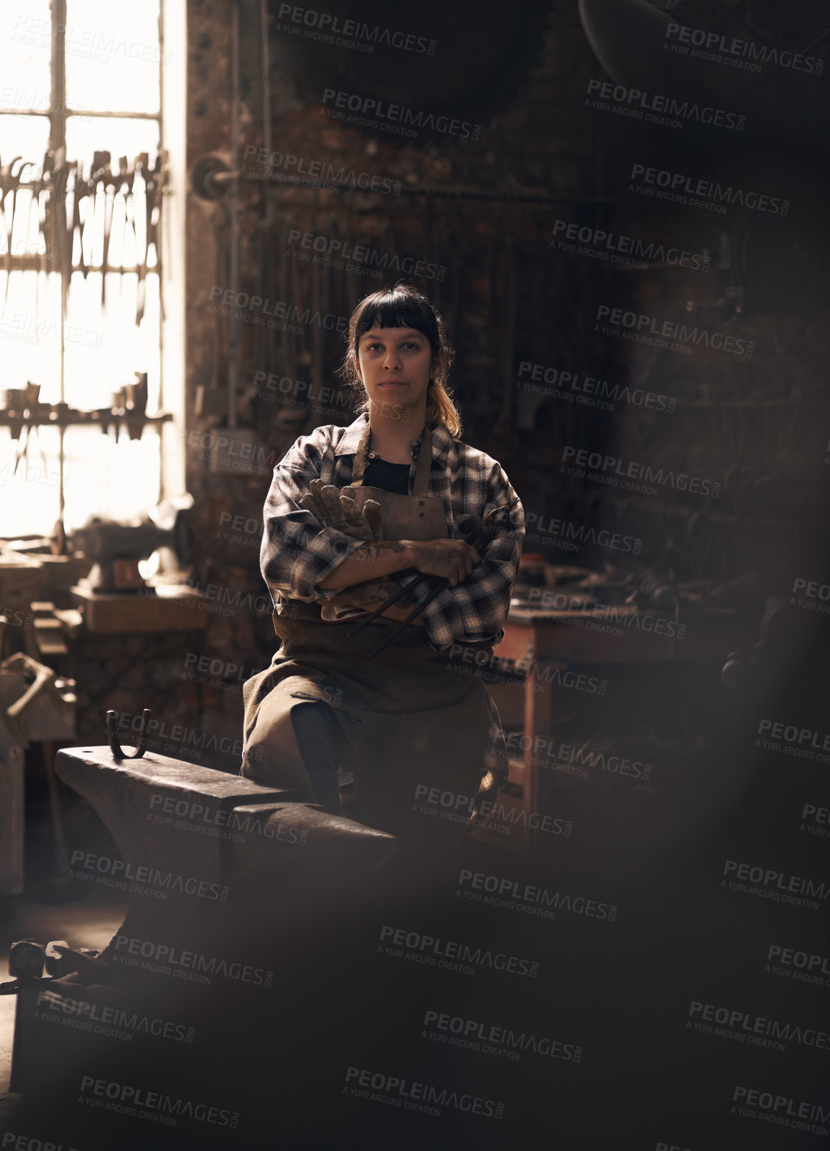 Buy stock photo Blacksmith, workshop and portrait of woman with tools for industry, manufacturing and machinery. Industrial factory, welding and female person for steel, iron and metal production for craftsmanship