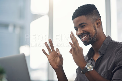 Buy stock photo Shot of a young businessman making an okay sign during a video call on a laptop in an office