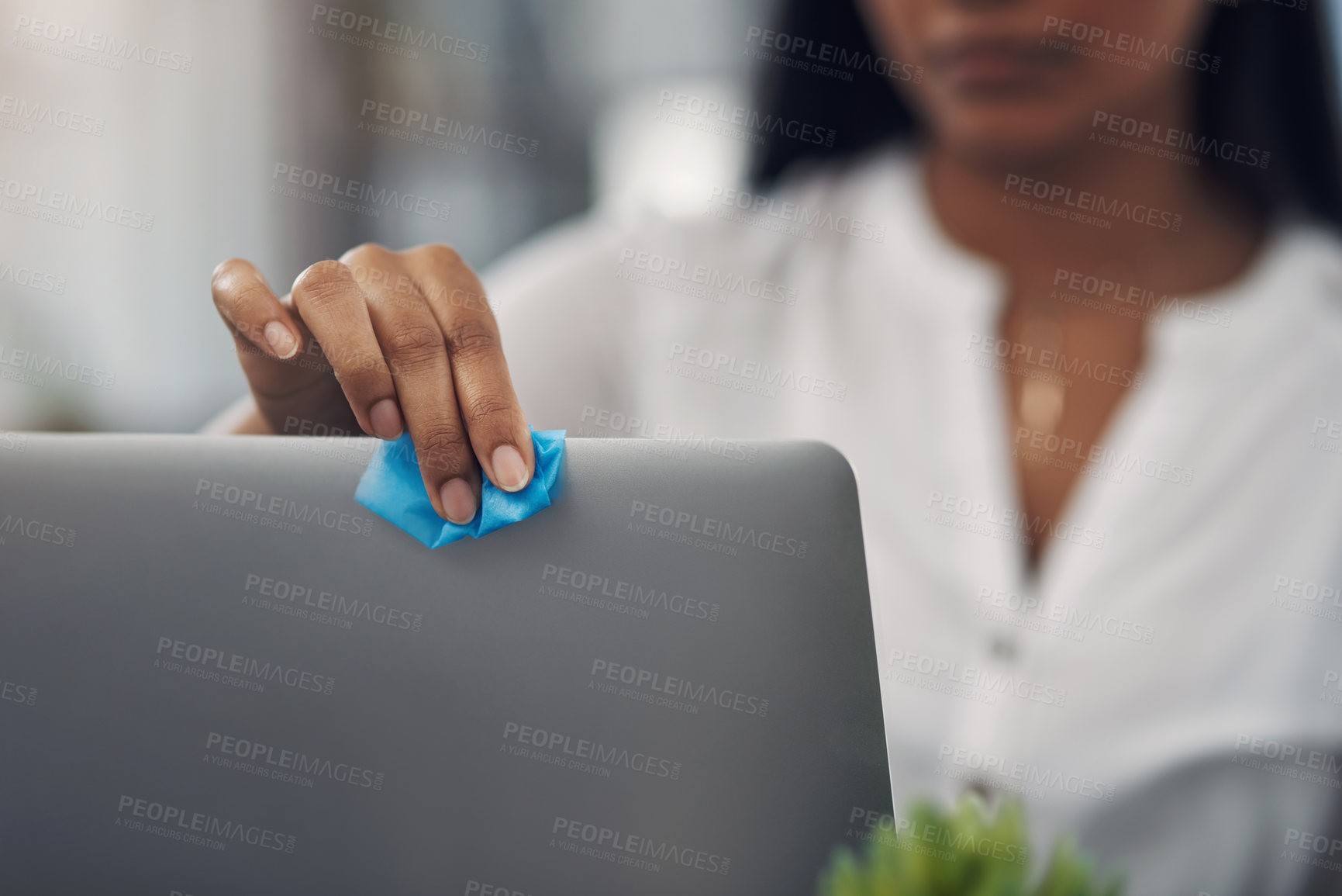 Buy stock photo Closeup shot of an unrecognisable businesswoman cleaning a laptop in an office