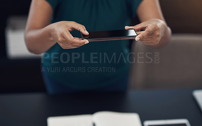 Buy stock photo Closeup shot of an unrecognisable businesswoman taking photos of her work in an office
