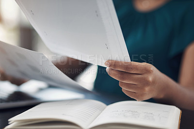 Buy stock photo Closeup shot of an unrecognisable businesswoman going through paperwork in an office