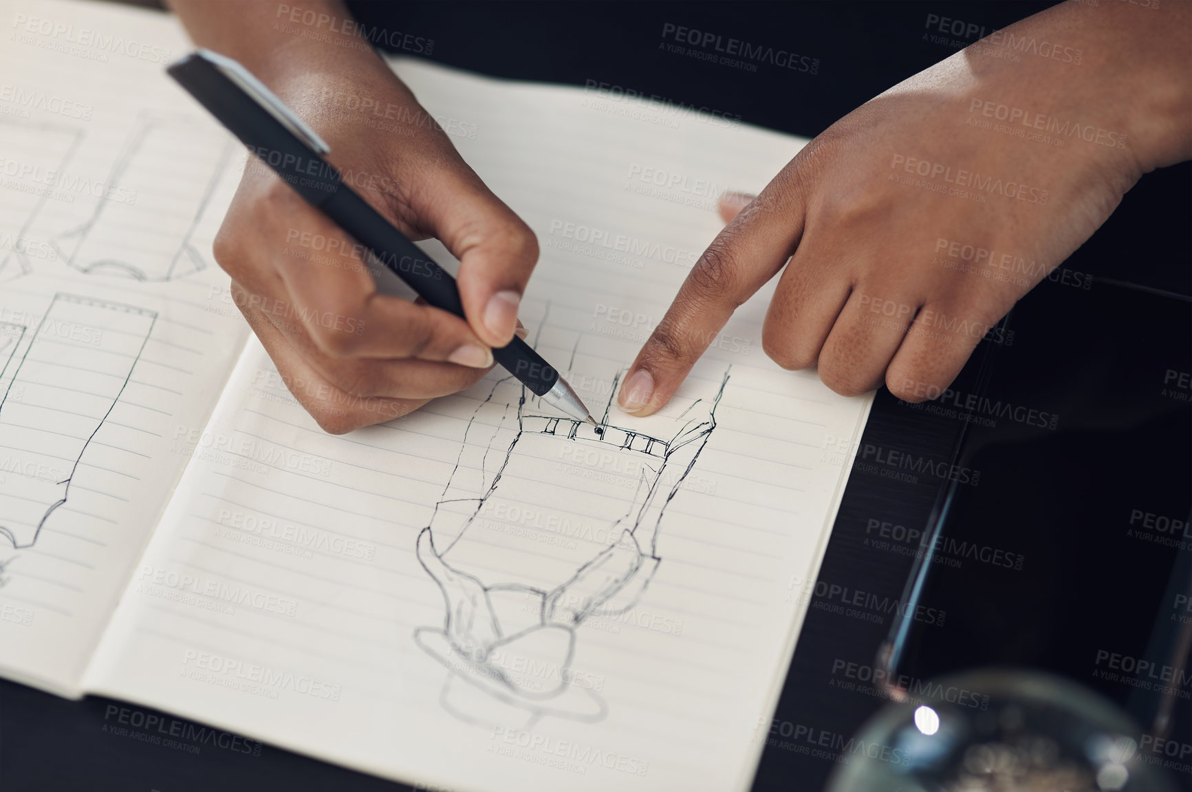 Buy stock photo Closeup shot of an unrecognisable designer sketching in a notebook in an office