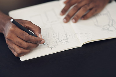 Buy stock photo Closeup shot of an unrecognisable designer sketching in a notebook in an office