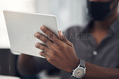 Buy stock photo Closeup shot of an unrecognisable businessman using a digital tablet in an office