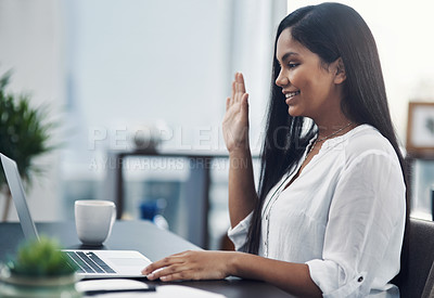 Buy stock photo Shot of a young businesswoman making a video call on a laptop in an office