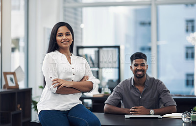 Buy stock photo Portrait of a young businesswoman in an office with her colleague in the background