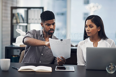 Buy stock photo Shot of two businesspeople looking stressed out while working together in an office