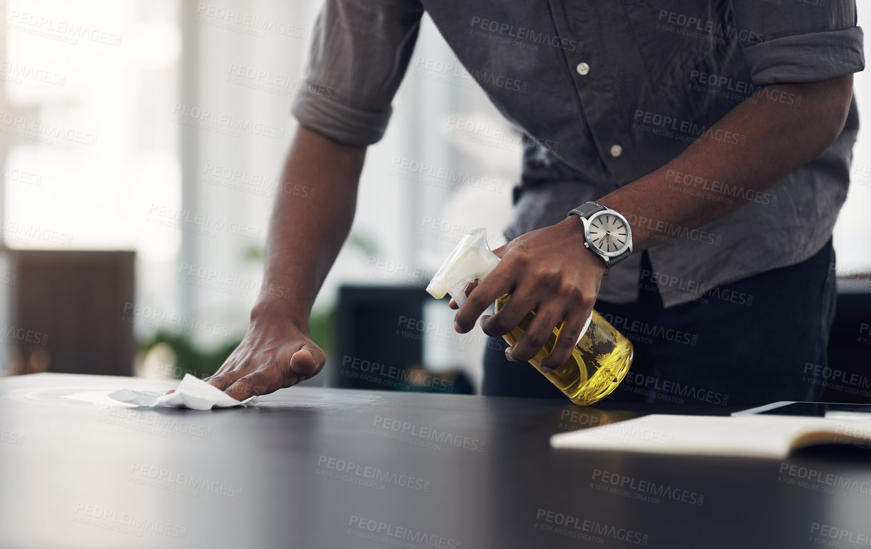 Buy stock photo Closeup shot of an unrecognisable businessman cleaning a workspace in an office