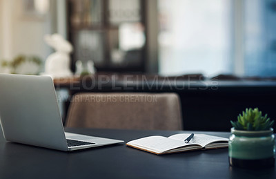Buy stock photo Still life shot of a laptop and notebook on a table in an office