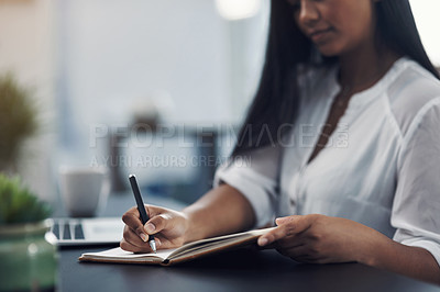 Buy stock photo Closeup shot of an unrecognisable woman writing notes in an office