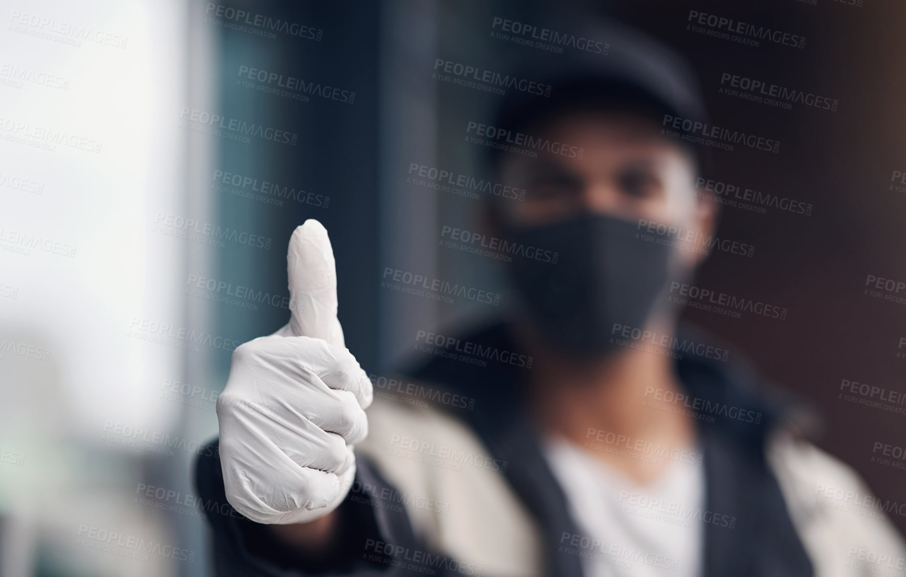 Buy stock photo Shot of a masked young man showing thumbs while making a home delivery