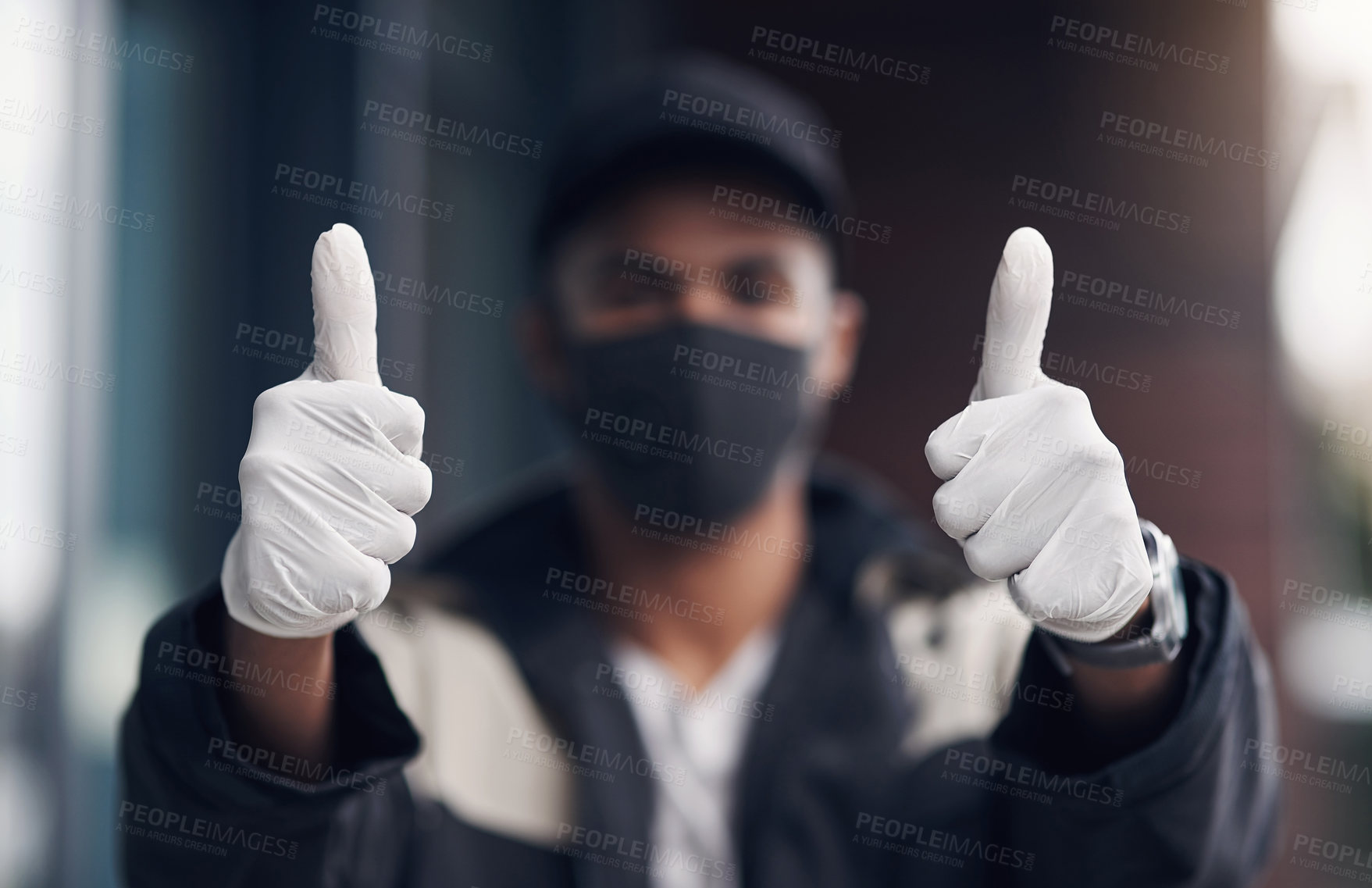 Buy stock photo Shot of a masked young man showing thumbs while making a home delivery