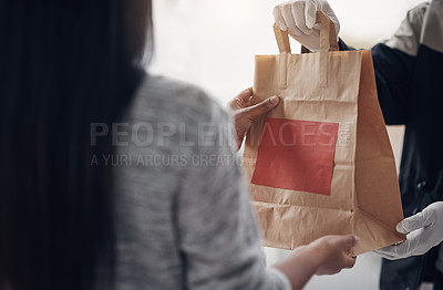 Buy stock photo Shot of an unrecognisable man wearing gloves while delivering takeout to a customer at home