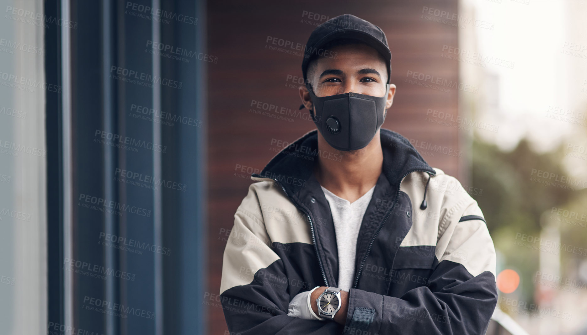 Buy stock photo Shot of a masked young man making a home delivery