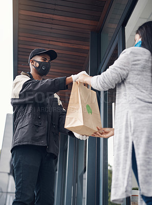 Buy stock photo Shot of a masked young woman receiving a takeout delivery at home
