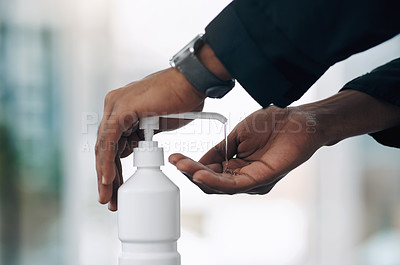 Buy stock photo Shot of an unrecognisable man disinfecting his hands with hand sanitiser