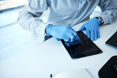 Buy stock photo Closeup shot of an unrecognisable businessman cleaning a digital tablet in an office