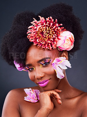 Buy stock photo Flowers, black woman and portrait with flowers for beauty, creative and spring makeup. Natural, cosmetics and female model with floral on face in studio for aesthetic, self love and organic skincare.